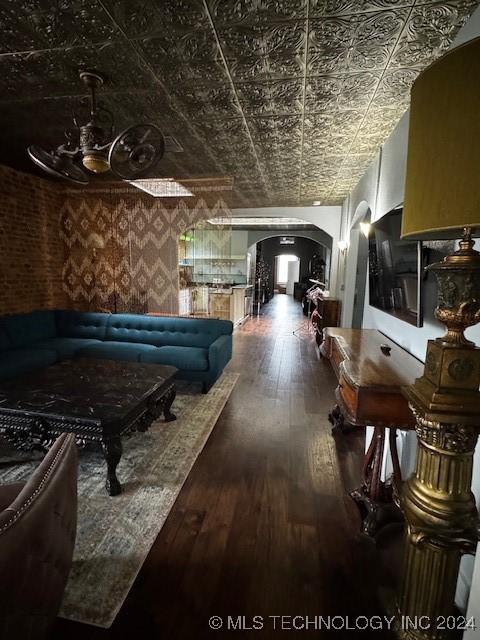 8 W Main St, Ardmore, OK 73401 - living area with arched walkways, an ornate ceiling, and dark wood-type flooring