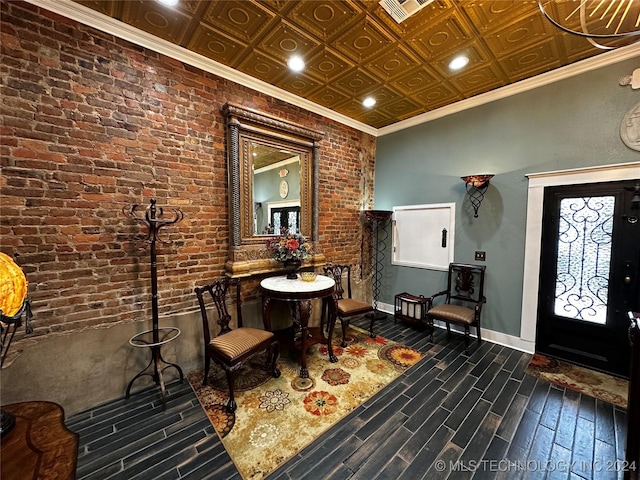 entryway featuring crown molding, dark wood-type flooring, and brick wall