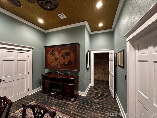 hallway with ornamental molding and dark wood-type flooring