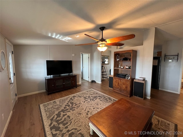 living room featuring dark hardwood / wood-style flooring and ceiling fan