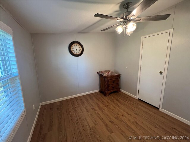 unfurnished bedroom with ceiling fan and dark hardwood / wood-style flooring