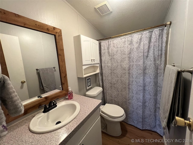 bathroom featuring vanity, lofted ceiling, hardwood / wood-style flooring, toilet, and a textured ceiling