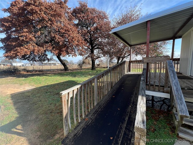 wooden terrace with a yard