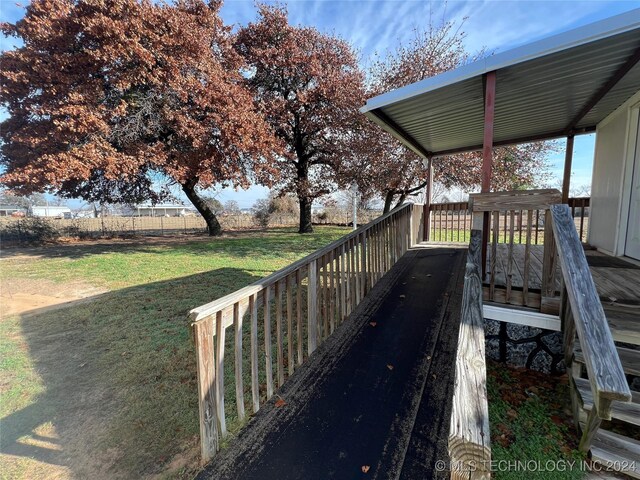 wooden terrace with a lawn