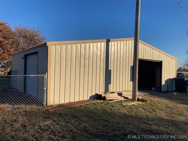 view of outbuilding with a yard and a garage