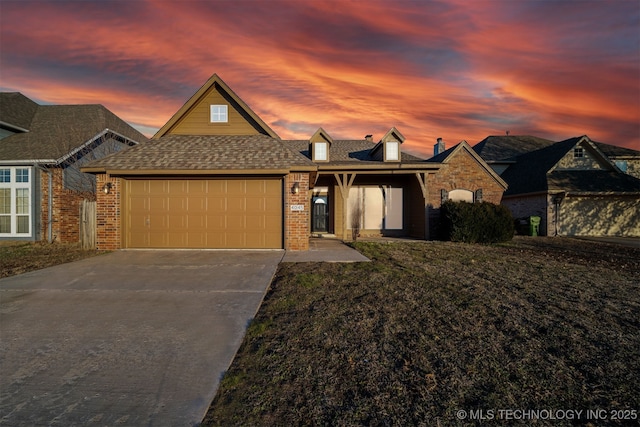 view of front of house featuring a garage and a yard