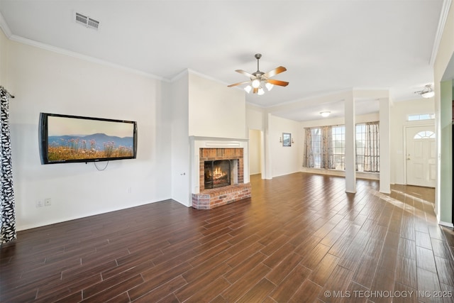 unfurnished living room with ceiling fan, crown molding, and a fireplace