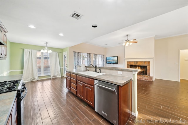 kitchen with sink, a wealth of natural light, range with gas stovetop, a center island with sink, and stainless steel dishwasher