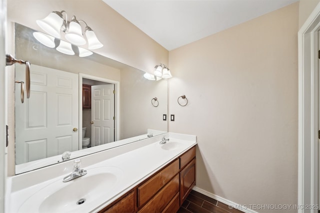 bathroom featuring vanity and toilet