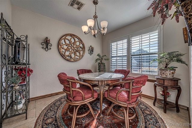 tiled dining space featuring a notable chandelier