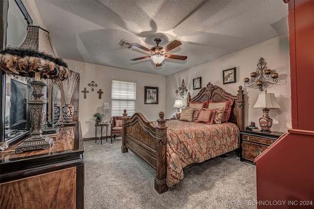 bedroom with carpet, ceiling fan, and a textured ceiling