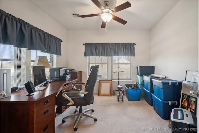 carpeted office featuring ceiling fan