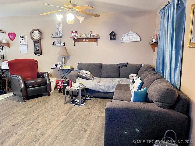 living room featuring ceiling fan and wood-type flooring