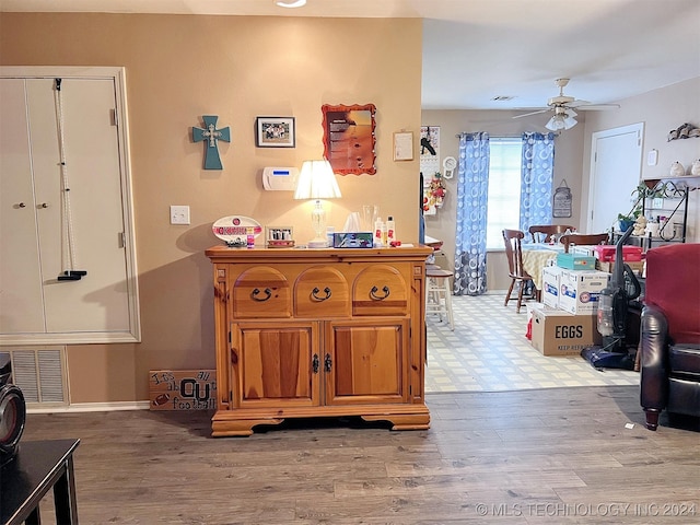 interior space with ceiling fan and light hardwood / wood-style flooring