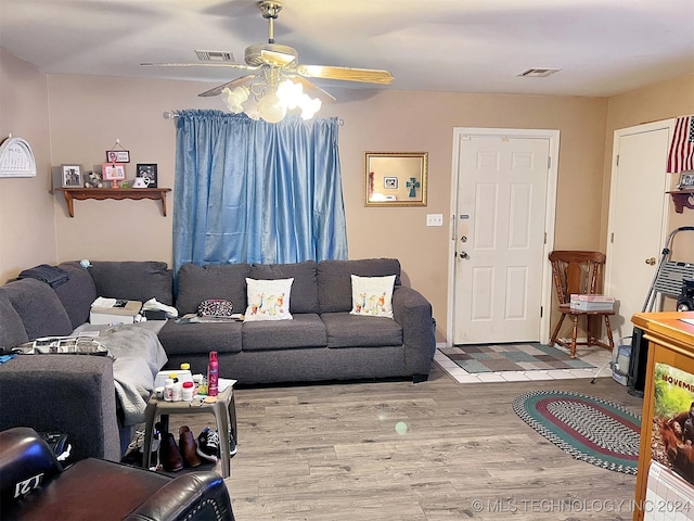 living room featuring light hardwood / wood-style floors and ceiling fan