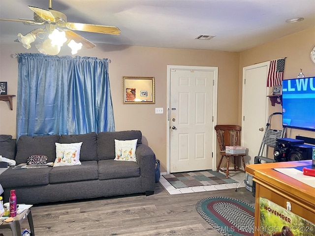 living room with ceiling fan and wood-type flooring