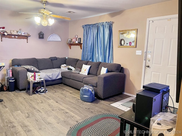 living room featuring hardwood / wood-style floors and ceiling fan