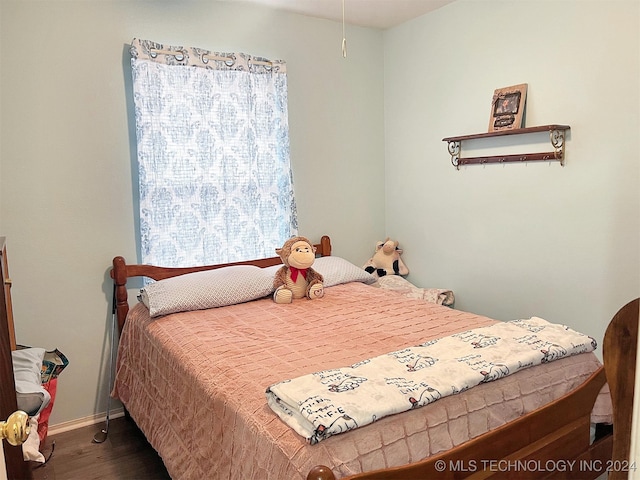 bedroom featuring dark wood-type flooring