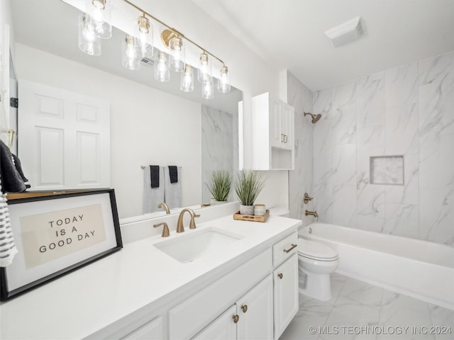 full bathroom featuring vanity, tiled shower / bath combo, and toilet