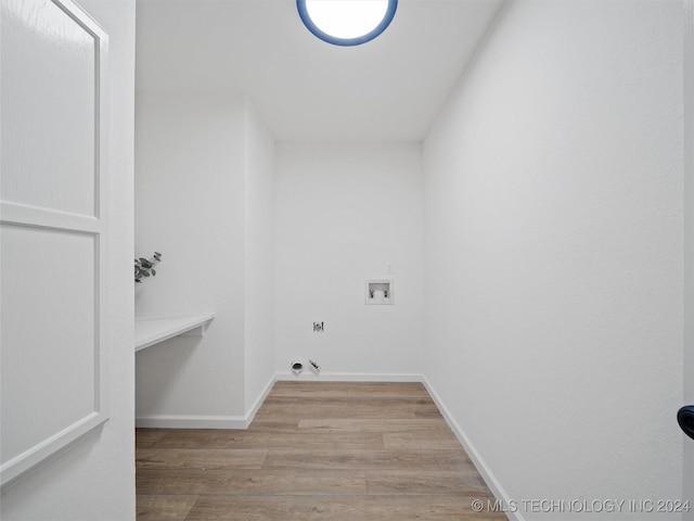 washroom with light wood-type flooring and hookup for a washing machine