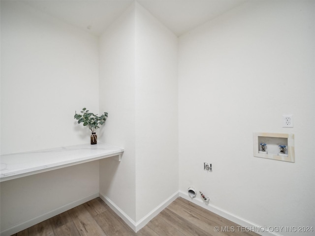 washroom with electric dryer hookup, light hardwood / wood-style floors, gas dryer hookup, and hookup for a washing machine