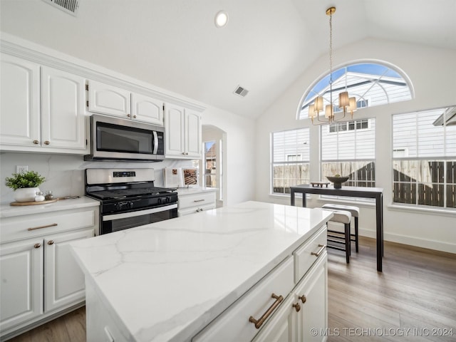 kitchen featuring a notable chandelier, light hardwood / wood-style floors, white cabinetry, and stainless steel appliances