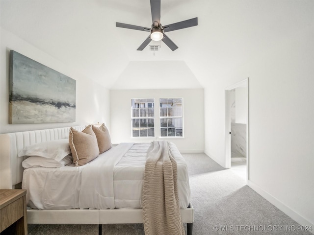 carpeted bedroom with ceiling fan and vaulted ceiling