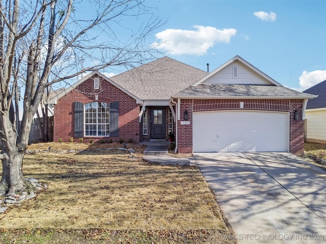 view of front of home with a front lawn and a garage