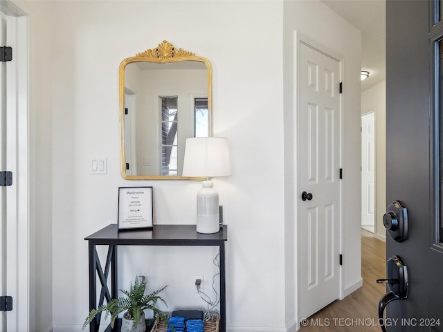 hall with hardwood / wood-style floors