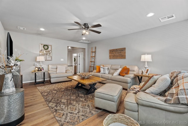 living room featuring hardwood / wood-style flooring and ceiling fan