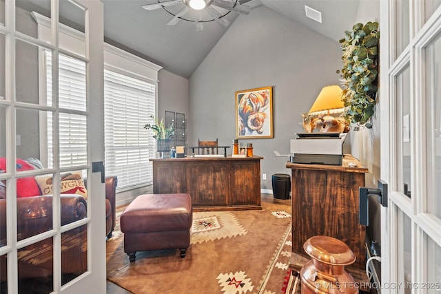 carpeted office featuring lofted ceiling and french doors