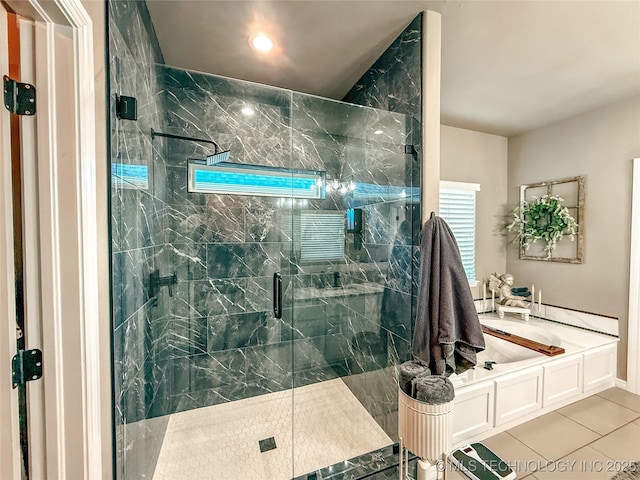 bathroom with tile patterned flooring and shower with separate bathtub