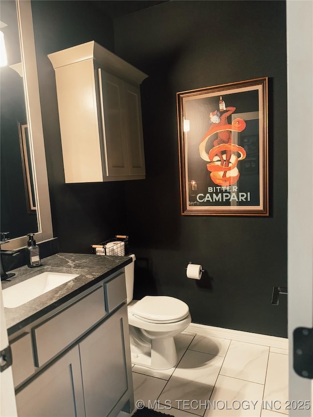 bathroom featuring tile patterned floors, vanity, and toilet