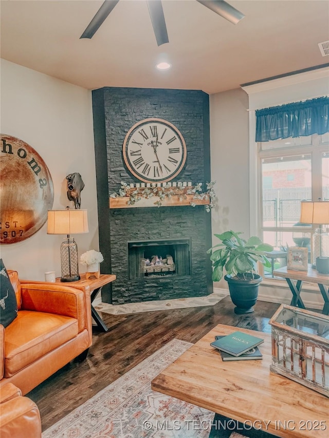 living room with hardwood / wood-style flooring and a fireplace