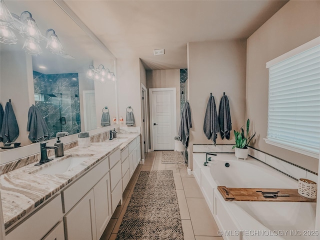 bathroom with tile patterned flooring, vanity, and shower with separate bathtub