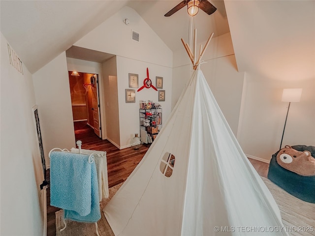 recreation room featuring hardwood / wood-style floors, ceiling fan, and lofted ceiling