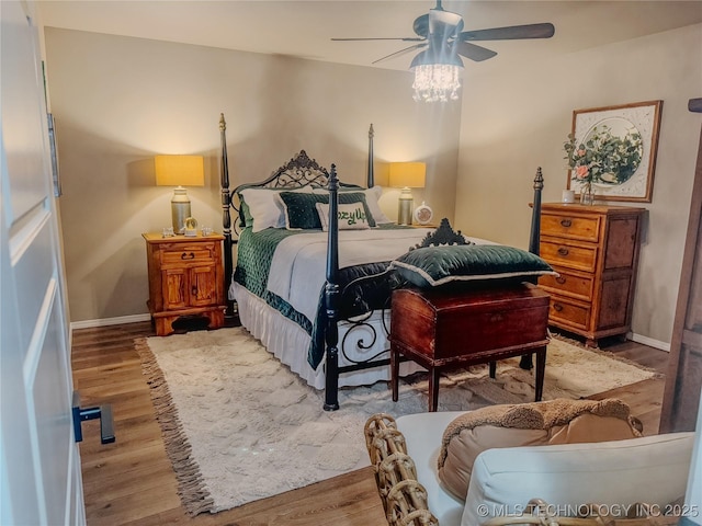 bedroom featuring ceiling fan and hardwood / wood-style flooring