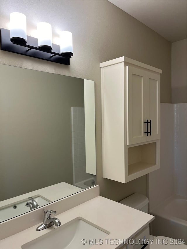 full bathroom with vanity, toilet, and  shower combination