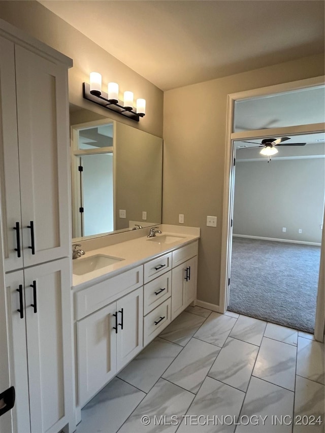 bathroom featuring ceiling fan and vanity