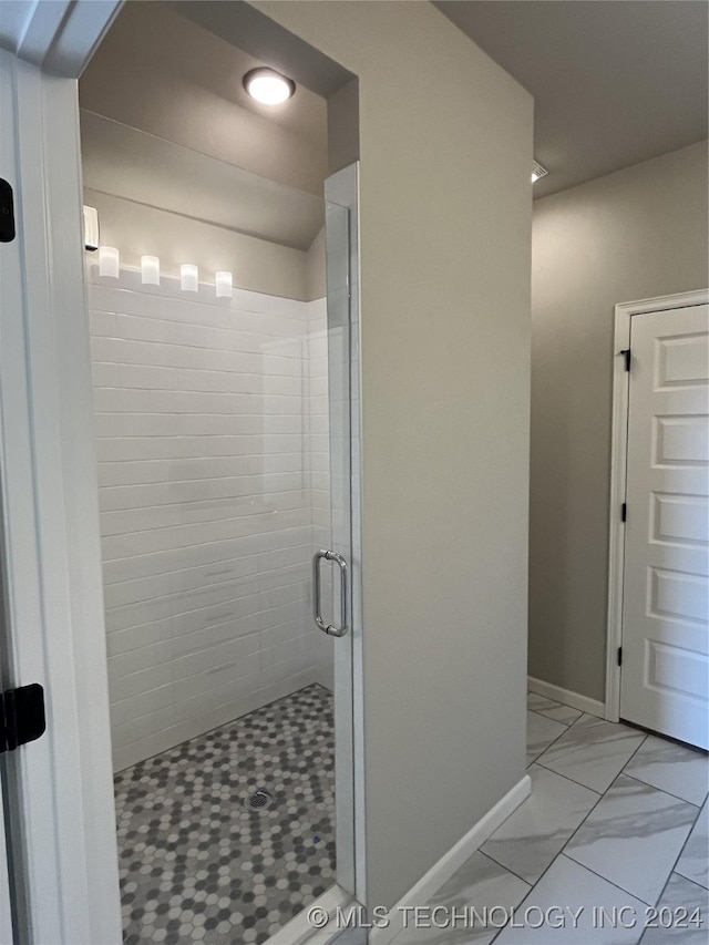 bathroom with a shower with door