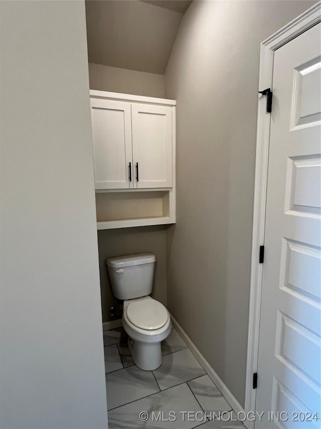 bathroom with vaulted ceiling and toilet