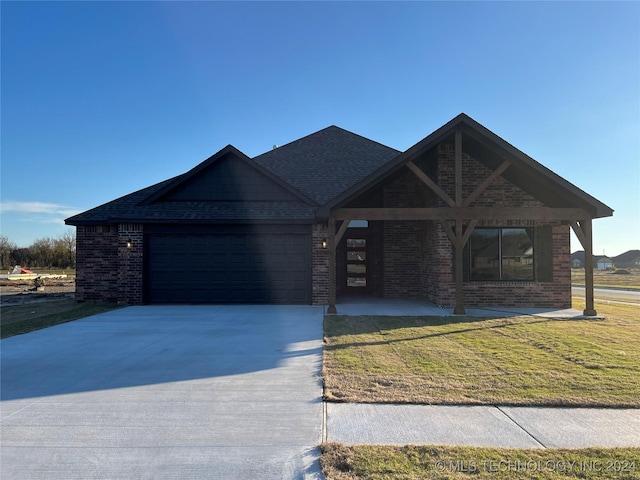 ranch-style house with a front yard and a garage