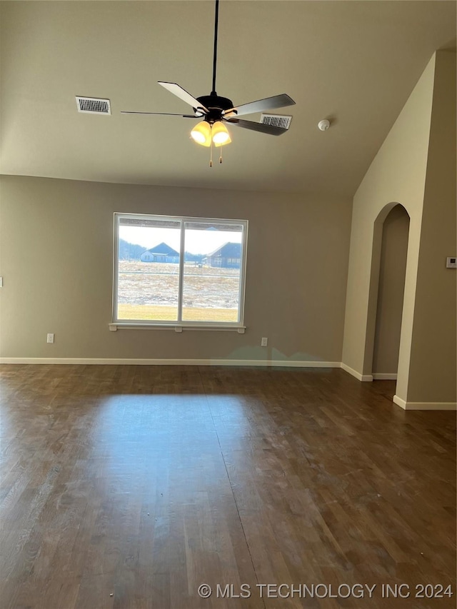 spare room with ceiling fan and dark hardwood / wood-style flooring