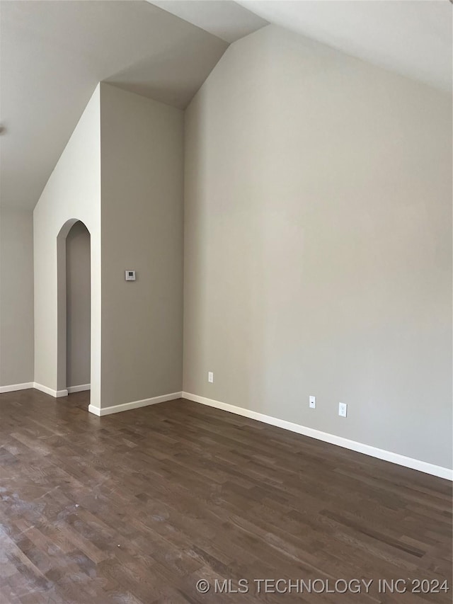 interior space with dark hardwood / wood-style floors and lofted ceiling