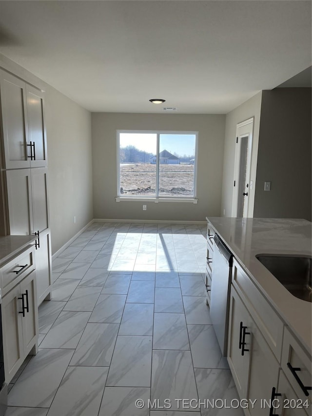 kitchen with white cabinets and stainless steel dishwasher