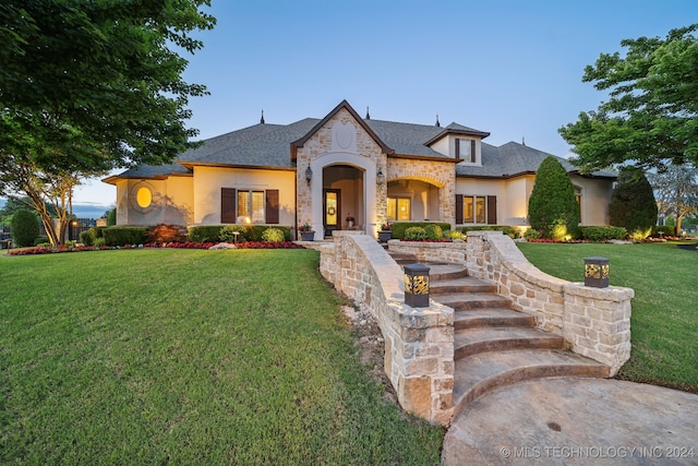 french country style house featuring a front lawn