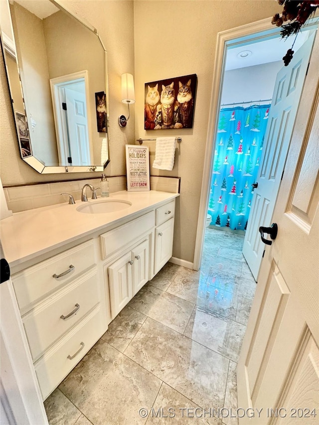 full bathroom with toilet, vanity, and a shower with shower curtain