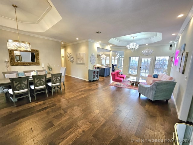 dining area featuring visible vents, baseboards, hardwood / wood-style floors, french doors, and a raised ceiling