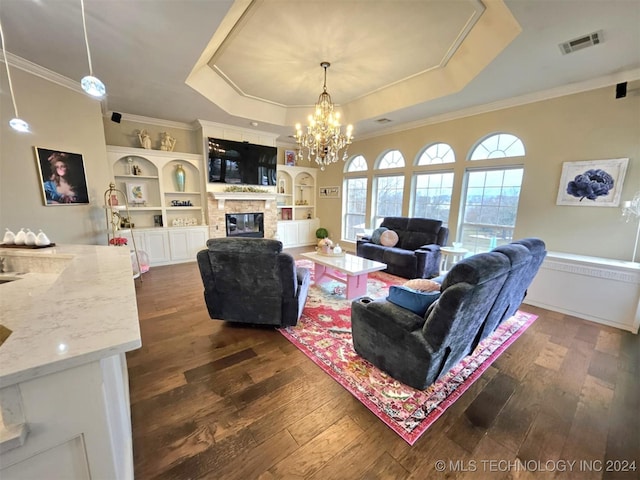 living room featuring visible vents, a raised ceiling, dark wood-type flooring, and a fireplace