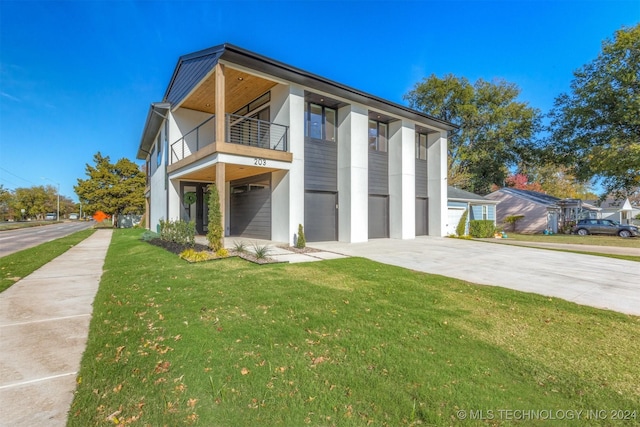 203 E 45th Ct, Tulsa, OK 74105 - modern home with driveway, a balcony, a garage, and a front yard